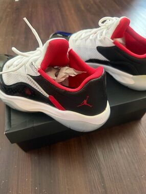 Jordan 11 Low Top Sneakers in White, Black & Red